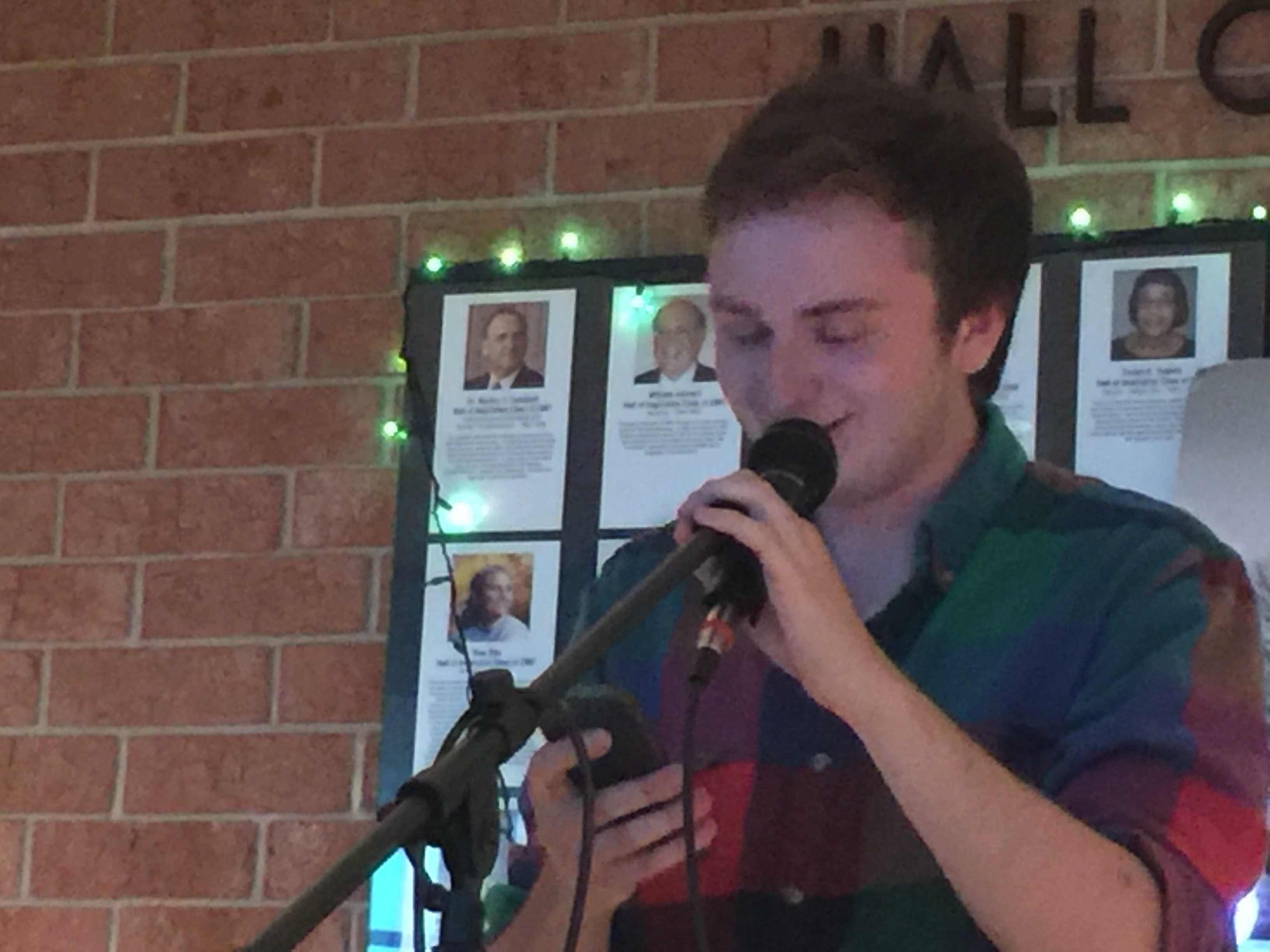 Jesse Honigberg, senior, shares a satirical poem at HHS Unplugged. Honigberg's poem criticized the current generation's overuse of technology. "I came up with this poem after watching videos about this generation, and I wrote it for my creative writing class," Honigberg stated. 