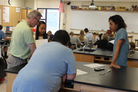 Mr. Richard Hubbell, science teacher, helps students with a lab last year. 