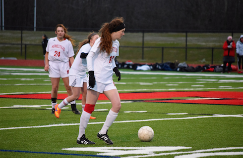 Brigid West, junior, prepares to pass the ball in a game earlier this season.