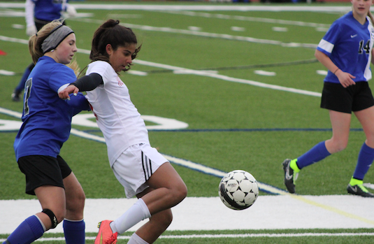 Haley Haddad, freshman, keeps the ball away from an Oshkosh West player in a game earlier this season.