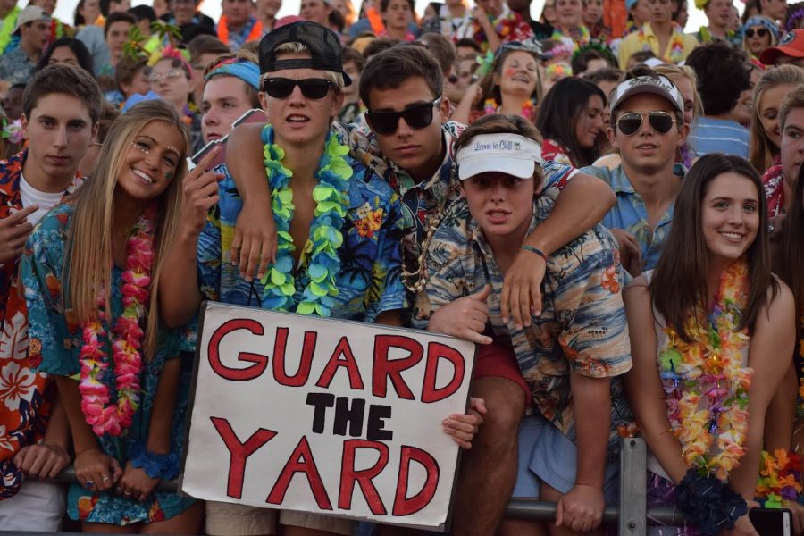 Student section leaders Matthew Klimkosky, senior, and Sam Gianakos, senior, are shown in the center of the photo above the Guard the Yard sign.