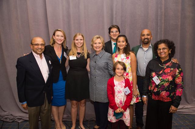Frances Mackinnon, sophomore, standing on the left of Hillary Clinton at an event in Chicago.