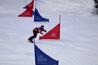Wilson competes for titles at a snowboarding event.