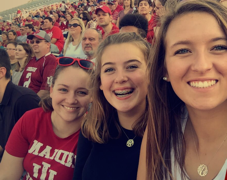 Megan Soyka (center), freshman, poses with sisters Ellen Soyka (left) and Katie Soyka (right) at an Indiana University football game. Soyka hopes to attend Indiana University after graduating Homestead.