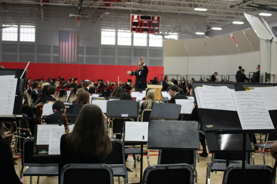 Mr. John Emanuelson, orchestra teacher, conducts the orchestra during the annual showcase. 