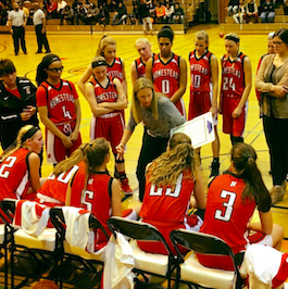 The girls varsity basketball team talks during the game against Whitefish Bay.