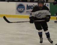 Paige Weir, number 16 on the ice, keeps a close eye on the puck.