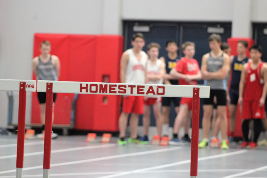 Boys track and field team prepares to hurdle. 