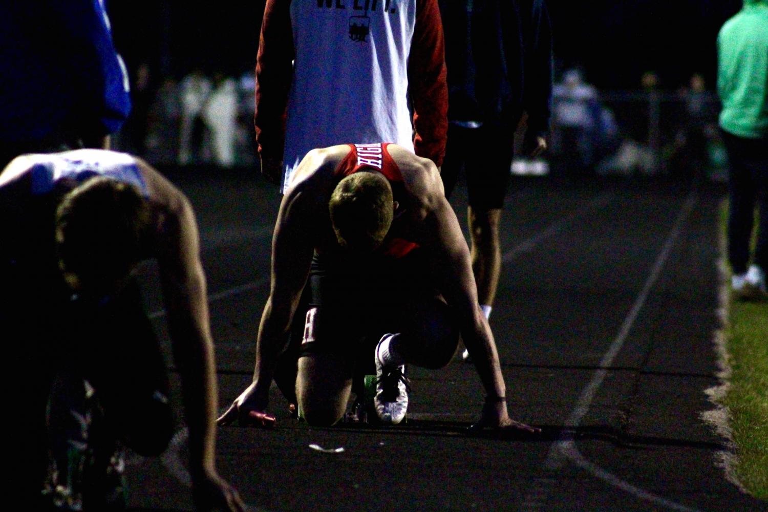 Bradley Woldt, junior, gets set in the blocks for the 1600 meter relay at the NSC Relay meet. 