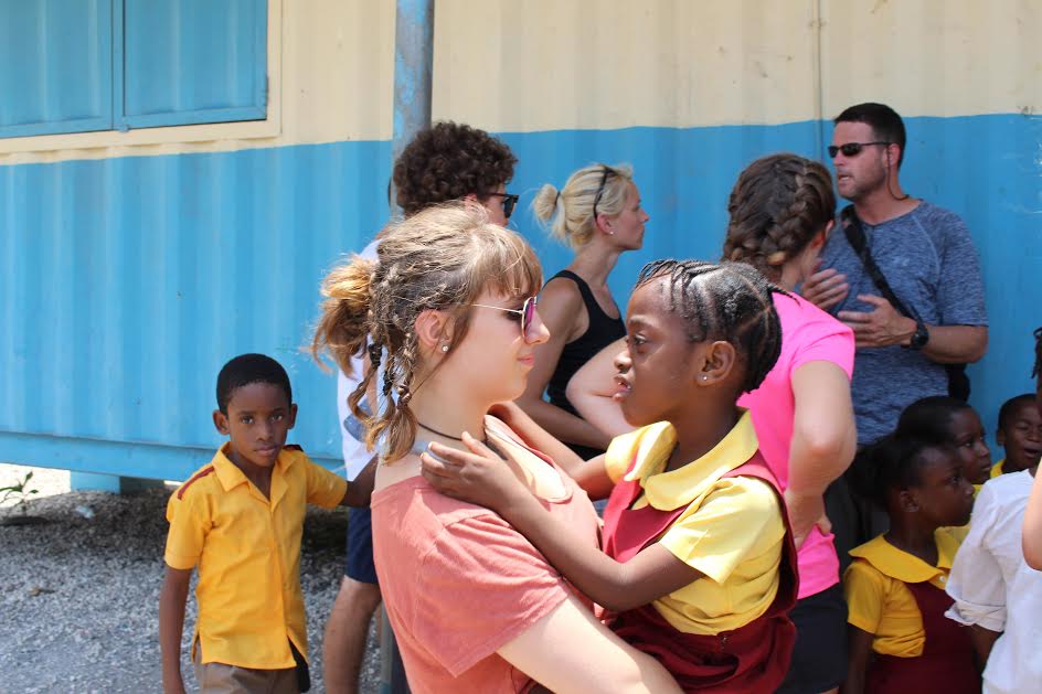 Clare Murphy, senior, spends time with a girl she met on the Jamaica trip. 