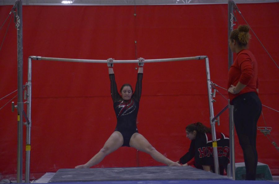 Olivia Rossman, junior, swings on the high bars. As a captain, she felt very passionately about the relocation. 