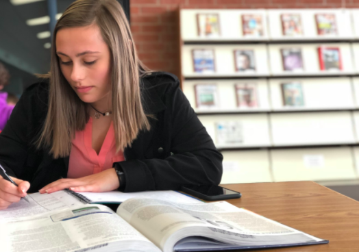 Rachel Sandlow, senior, uses her extra 20 minutes of study hall to complete a homework assignment.