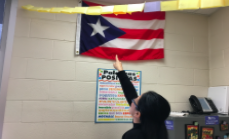 Migdalia Dybro, the new Spanish teacher points to the Puerto Rican flag, to show where her family is from, and opens up about why she loves about teaching Spanish.  
