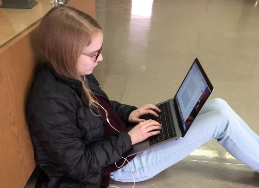 Lizzie Wilkerson, freshman, types her exam for Health. “Listening to music really helps me calm down and focus on what needs to be done,” said Wilkerson.
