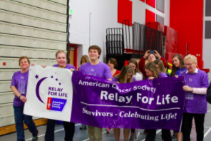 PROUD IN PURPLE The honorary cancer survivors start off the event by walking the first lap of the night. Some of them stayed the whole night with their peers, while most of the adults left to get some sleep. Survivor Drew Wagner, junior, describes his favorite part of the night: “It was immensely powerful to watch the girls shave and donate their hair to such a wonderful cause, without a doubt it will make someone’s day."