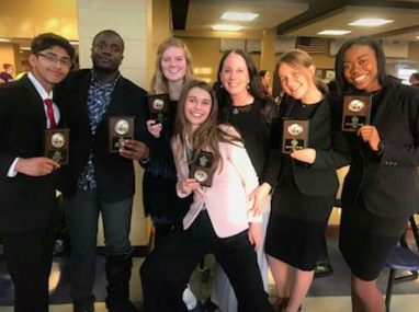 Forensics national qualifiers smile with Mrs. Cicero, forensics coach. 