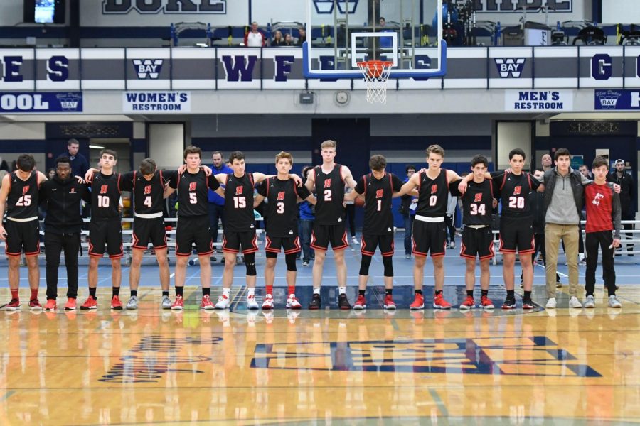 Homestead Boys Basketball team together for the national anthem at Whitefish Bay High School. 