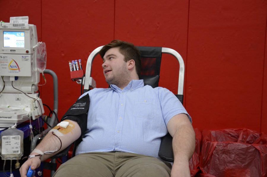 David Schmich, senior, participates in the blood drive by donating his red blood cells. 