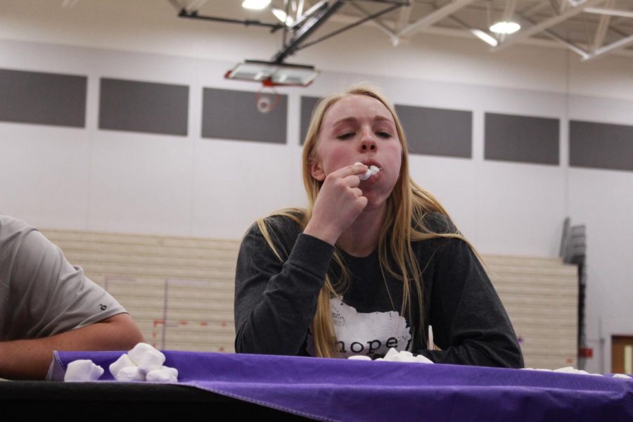 Anna Lalande, senior, stuffs her face with marshmallows for a good cause. 