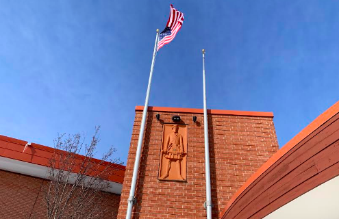 The United States flag waves high over Homestead High School on the Highlander walkway, greeting students and staff walking into the school.