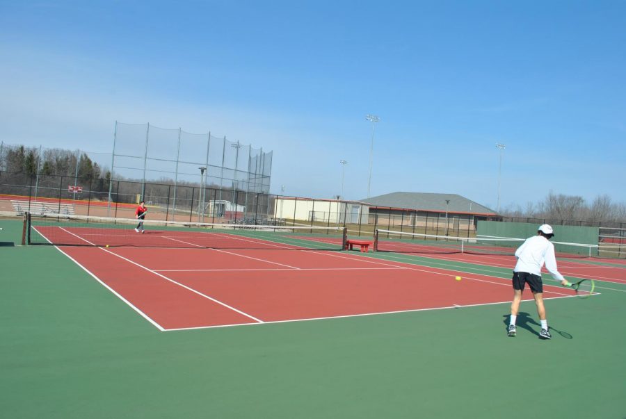 Zach Sprinkmann (left), sophomore, and Eli Eiseman (right), senior, warm up before the final day of tryouts.