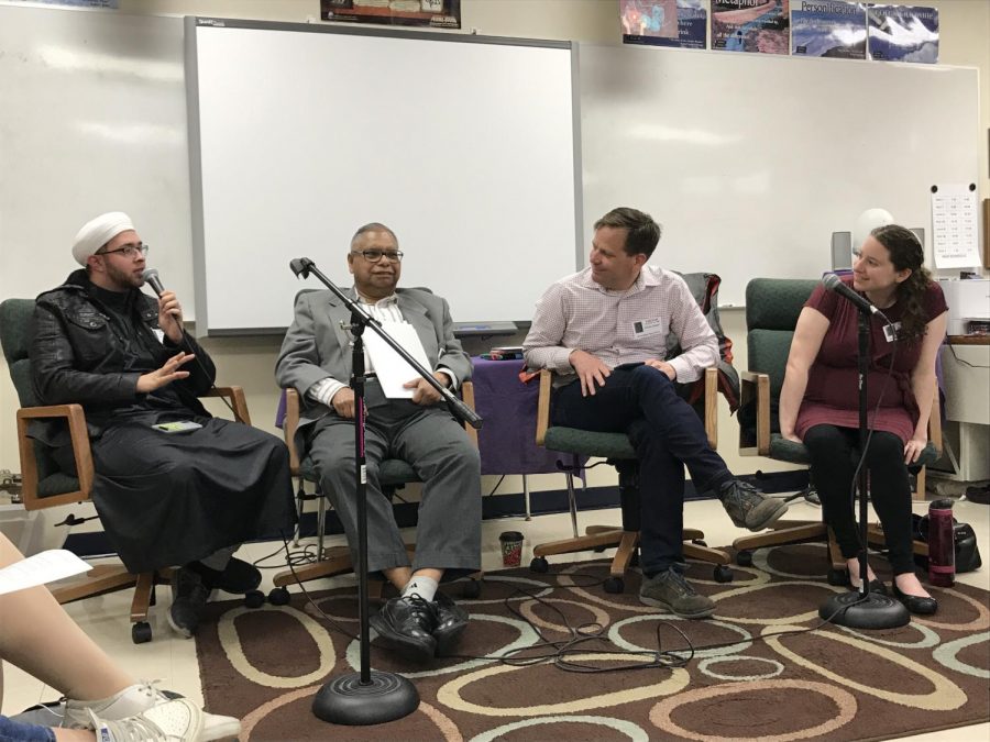 Imam Saif, Kishore Acharya, Pastor Keith Steiner, and Rabbi Jennifer Mangold answer questions during a panel discussion on religious perspectives.