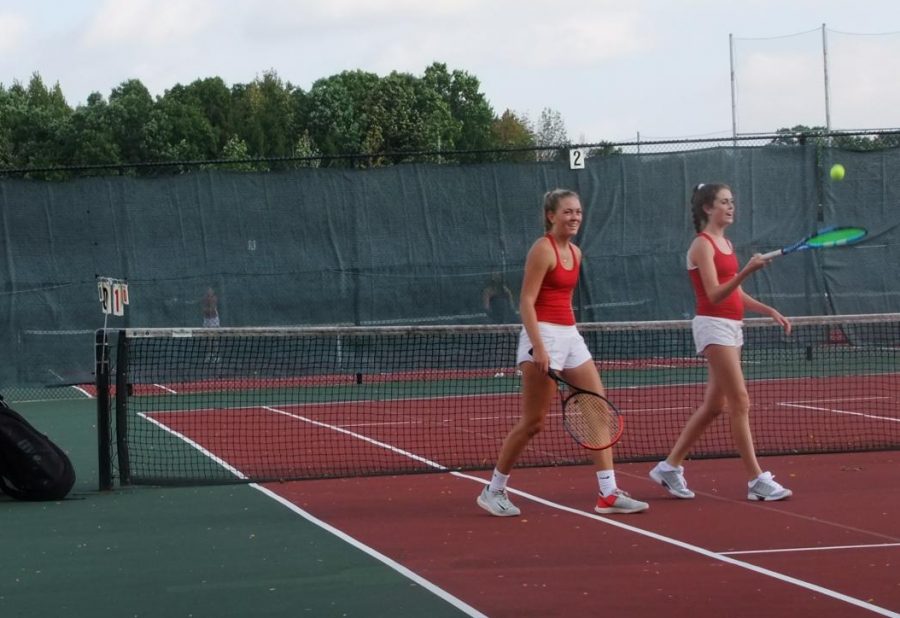 Bridget Brown (left), senior, and Ellie Sprinkmann (right), sophomore, walk off of the court after their successful match.