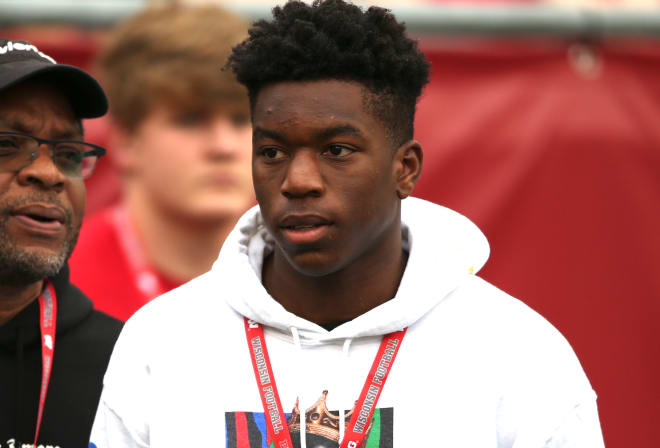 Adebogun+stands+on+the+field+during+his+official+visit+to+UW+Madison.