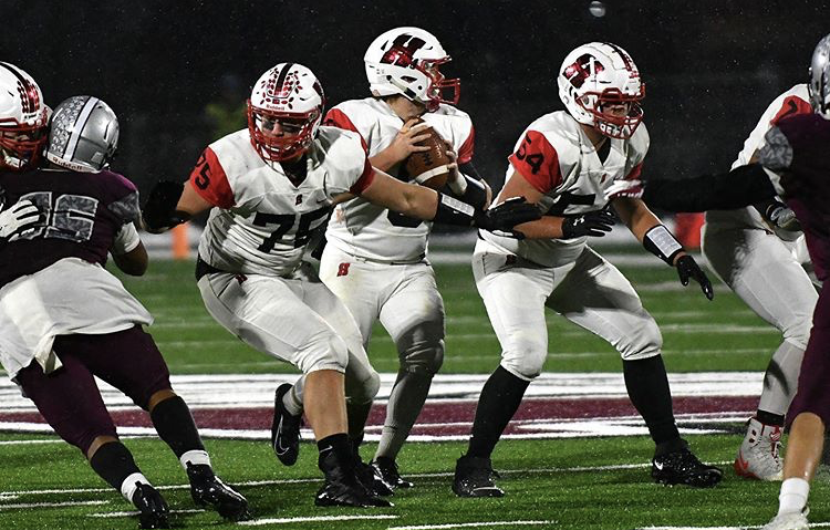 The offensive line  battles it out against Menomonee Falls during a playoff game on Nov. 1, 2019. 