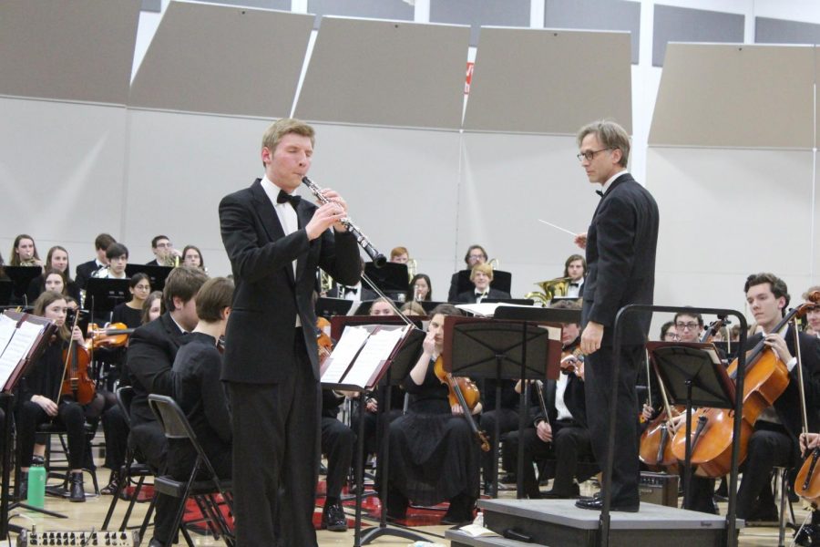 Grayson Eichmeier, senior, plays the oboe solo in front of the audience for the orchestra estival.