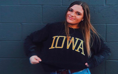 Hartlieb poses for a picture wearing University of Iowa apparel.
