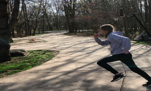 Emma Kramer, sophomore, maximizes space by doing sprints outside.