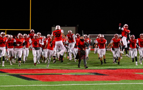 The boys run out to the field before their game in 2019.