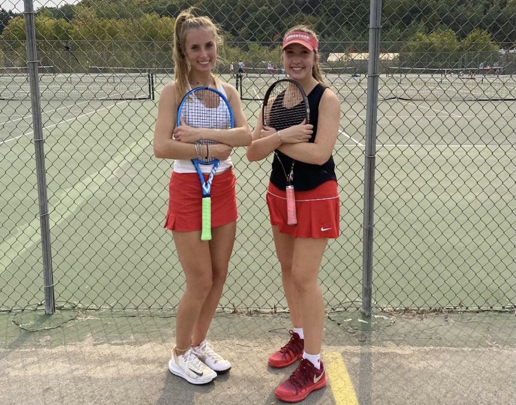 Andrea Schwalbach (right) posing with her doubles partner, Olivia Kowaleski (left), after a winning match during the 2020-2021 season.