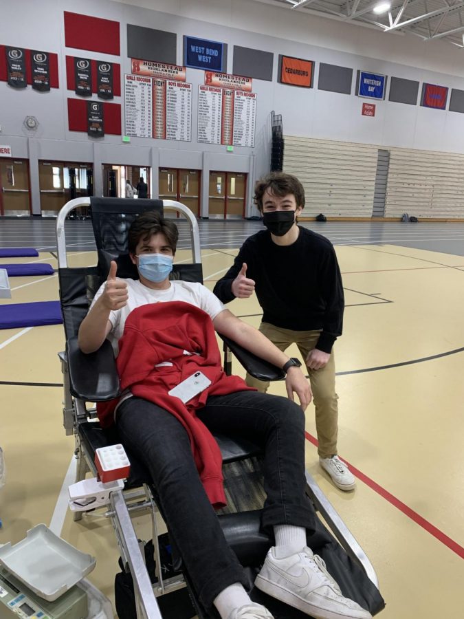 Daniel Zelenovski, junior, and Michael Florsheim, junior, give a thumbs up as they donate blood.