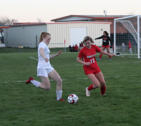 Caitlin OBrien, freshman,  fights for the soccer ball at the girls first game of the season.