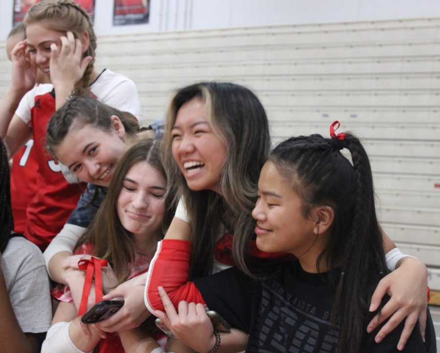 Maria Pramenko, Whitney Krueger, Grace Thao and Nora Raasch embrace each other during senior night. I’ve been able to click with a lot of people on the team, which is really helpful on and off the court, Pramenko said. 