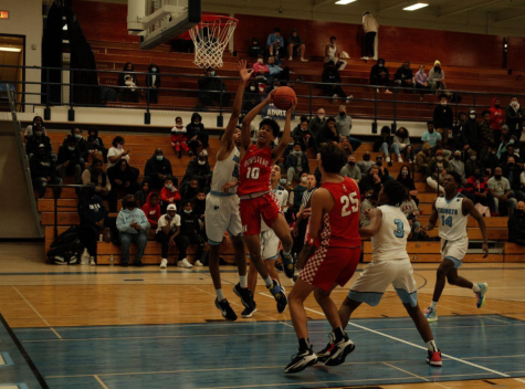 Trevor Polite, freshman guard, goes up for a layup in a conference game played against the Nicolet Knights.
