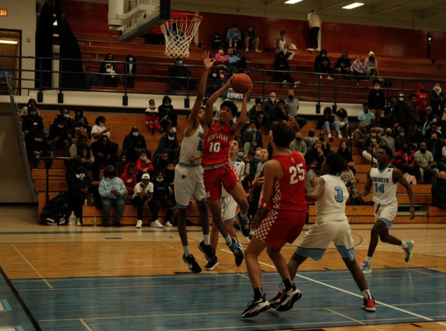 Trevor+Polite%2C+freshman+guard%2C+goes+up+for+a+layup+in+a+conference+game+played+against+the+Nicolet+Knights.