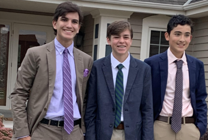 Patrick Brown (center) takes photos before homecoming with Matthew Seiberlich (left) and Mateo Reyes (right). This was their first homecoming. 