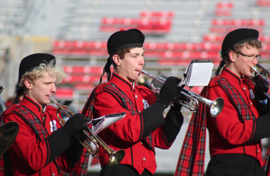 Zach Meyer, junior, Ethan Brown, junior, and Brian Franks, sophomore, play Soul Finger at halftime during the state football game. This was one of two songs they played, along with The Hokie Pokie. “It’s simple but groovy, and has some really good and fast parts,” Franks said.