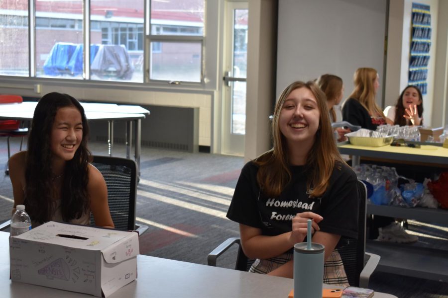 Mia Tsuchihashi, sophomore, and Haley Kerley, junior, collect donations for the Forensics team.