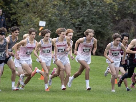 The boys varsity cross country team charges through the opening stretch of a mid-season race.