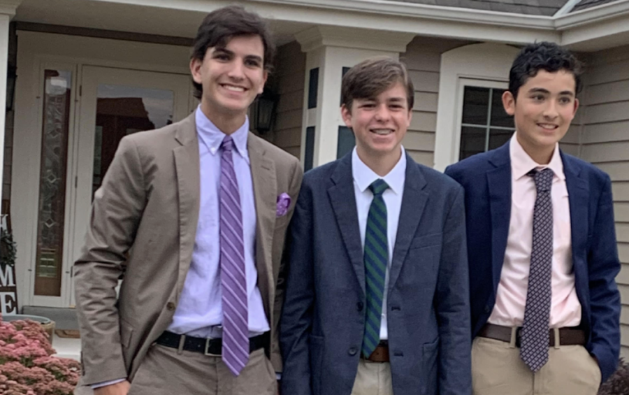 Mateo Reyes, freshman, (right) takes photos before homecoming with Matthew Seiberlich (left) and Patrick Brown, (center). This was their first homecoming. 