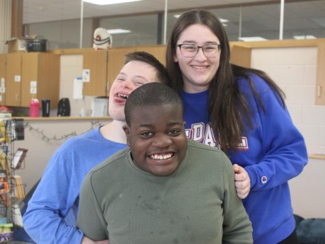 Clare Kunschke, Andrew Heinz and Ginou Tiako smile during class together. 
