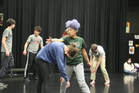 Members of the ensemble practice their choreography in the Black Box. 