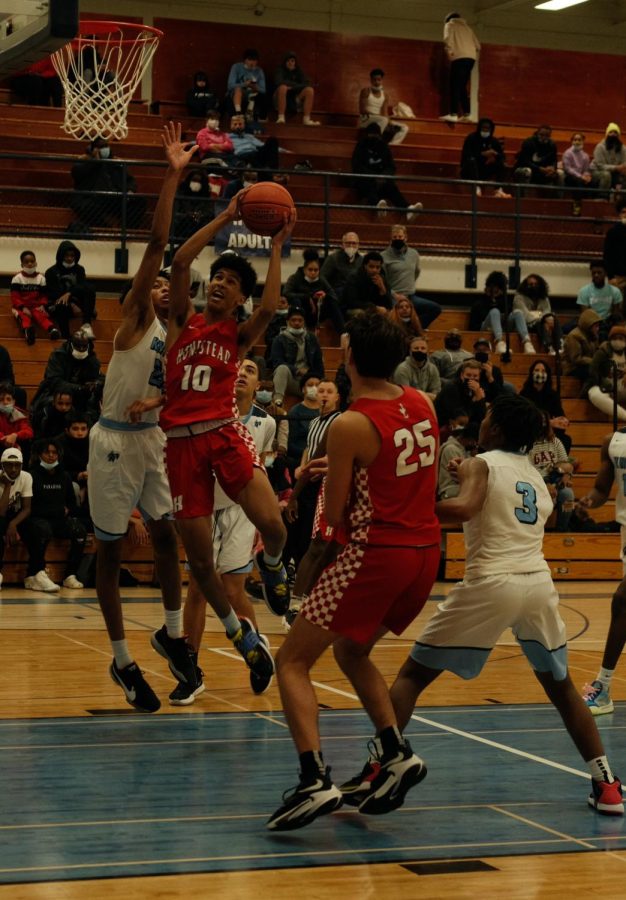 Trevor Polite, freshman, attacks the hoop during a basketball game. 