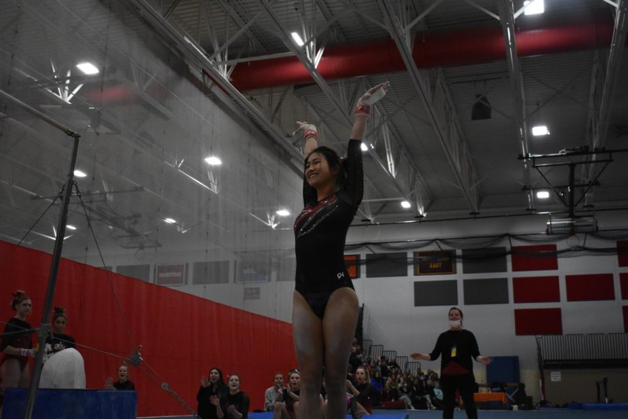 Lucy Gonzalez, senior, competes in a gymnastics meet. 