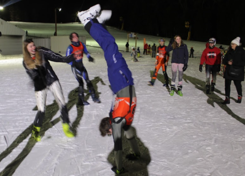 Last year’s ski team proves their strong bond on and off the hill by goofing around at their final race.