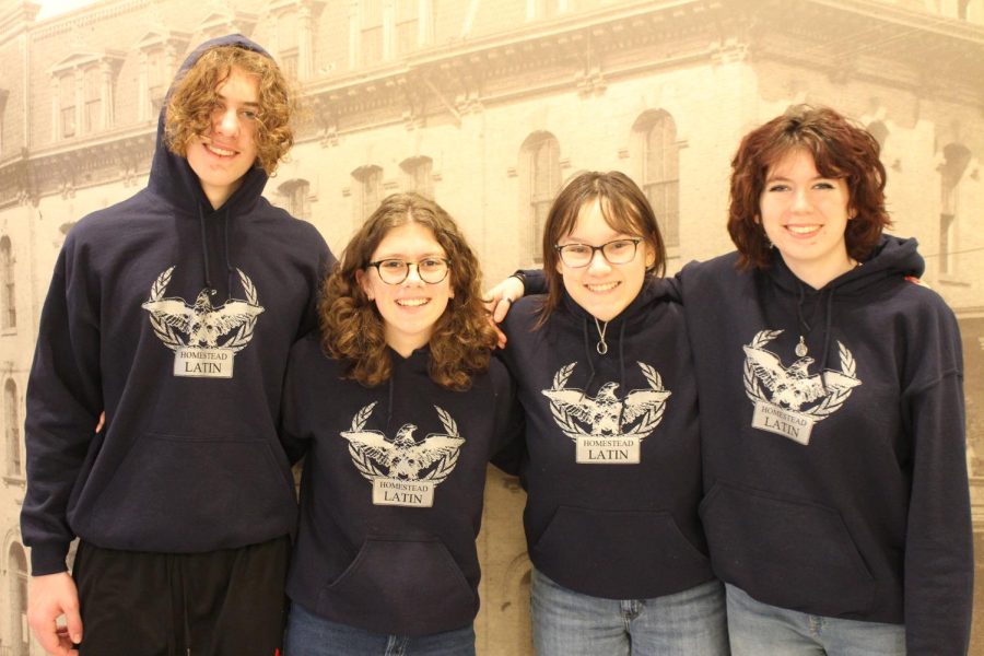 Emily Taylor (center right), poses with the first-place Latin I Certamen team of Luke LaLonde (left), Captain Charlotte King (center left), and Addison Drumm (right), freshmen, at the Latin State Convention.